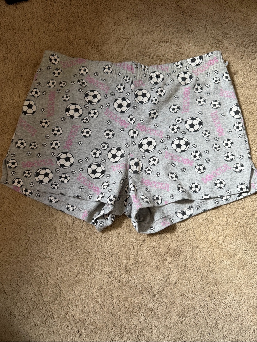 Grey and pink soccer shorts in a size youth XL/ adult Xs/ small